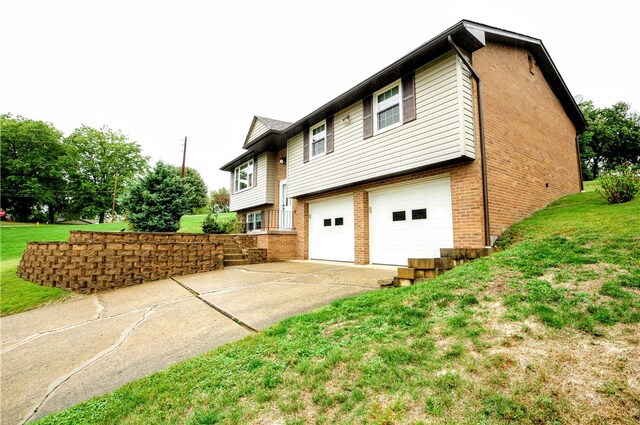 view of side of home featuring a garage and a lawn