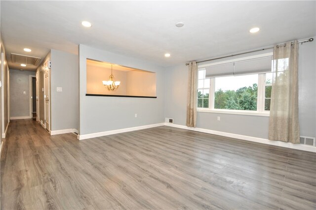 unfurnished room with hardwood / wood-style flooring