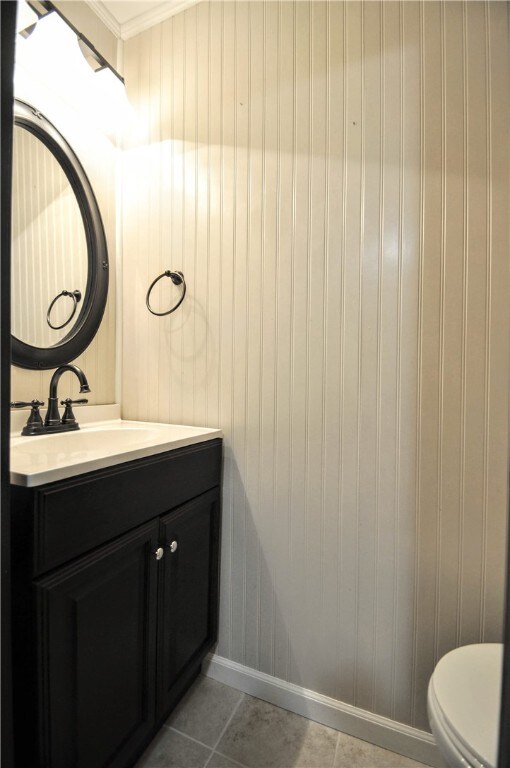 bathroom with ornamental molding, tile patterned floors, vanity, and toilet