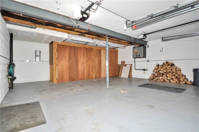 garage featuring electric panel and a garage door opener