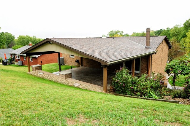 rear view of house featuring a yard and a patio area