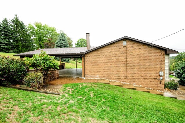 view of side of property with a lawn and a patio