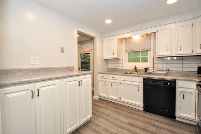 kitchen featuring dishwasher, tasteful backsplash, sink, white cabinets, and light hardwood / wood-style flooring