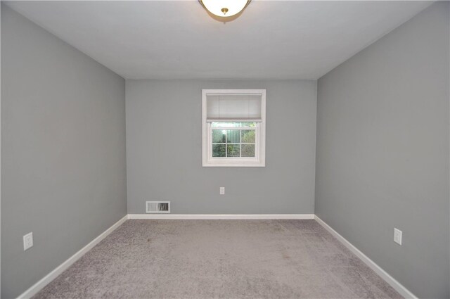 unfurnished room with light carpet