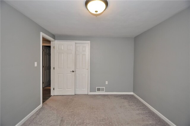 unfurnished bedroom with carpet and a closet