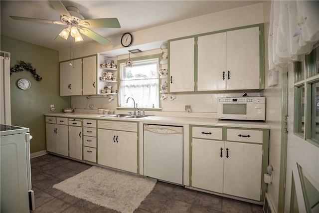 kitchen featuring white appliances, sink, and ceiling fan