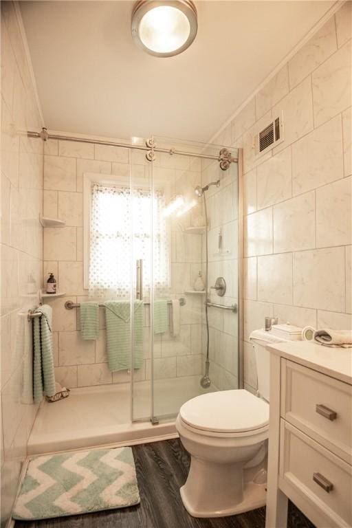 1820 N Hermitage Rd, Hermitage, PA 16148 - bathroom with toilet, tile walls, a stall shower, visible vents, and wood finished floors