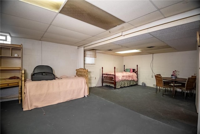 1820 N Hermitage Rd, Hermitage, PA 16148 - bedroom with concrete block wall, a paneled ceiling, and finished concrete floors