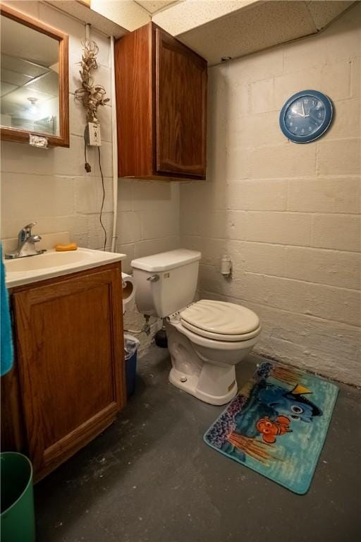 1820 N Hermitage Rd, Hermitage, PA 16148 - bathroom with concrete block wall, vanity, toilet, and unfinished concrete flooring
