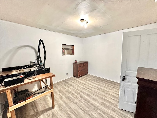 office featuring light hardwood / wood-style floors and a wall mounted AC