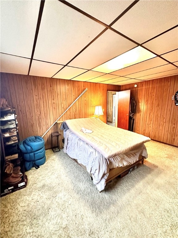 bedroom featuring a drop ceiling, wooden walls, pool table, and carpet floors