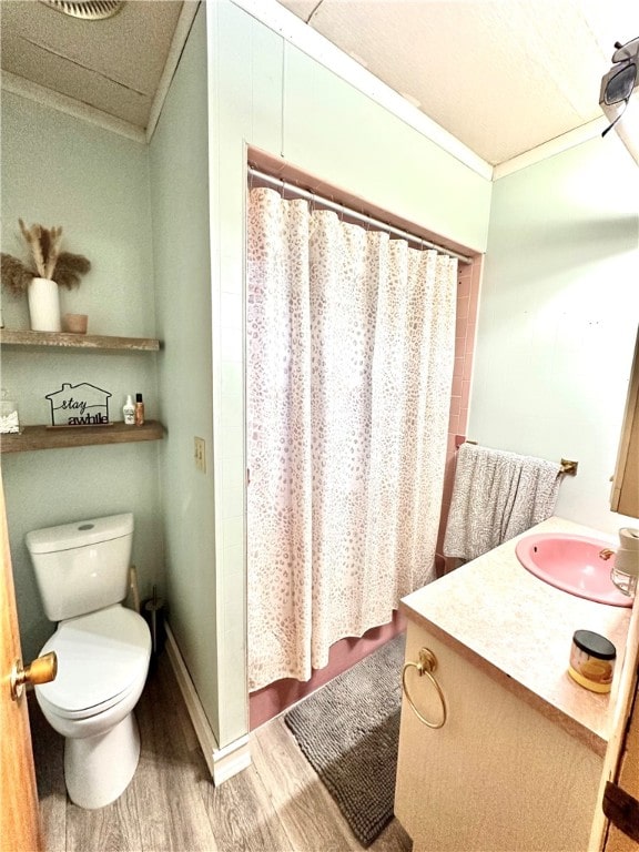 bathroom with vanity, wood-type flooring, crown molding, toilet, and a shower with shower curtain