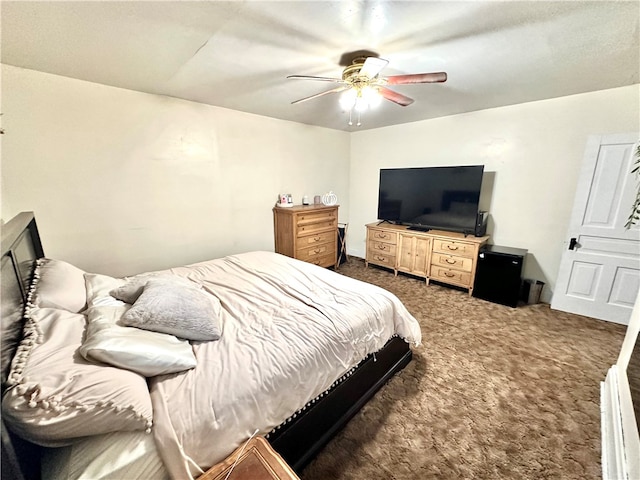 bedroom with dark colored carpet and ceiling fan