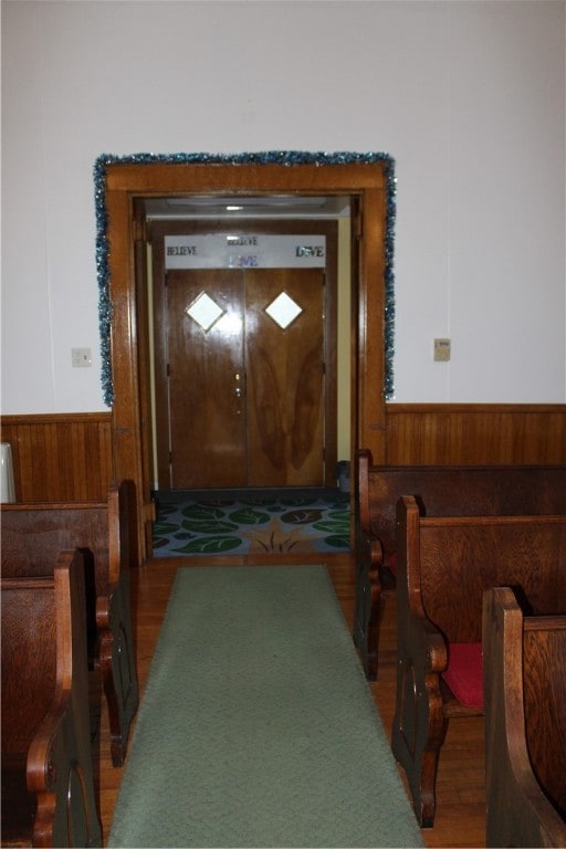 interior space with wood-type flooring and wood walls