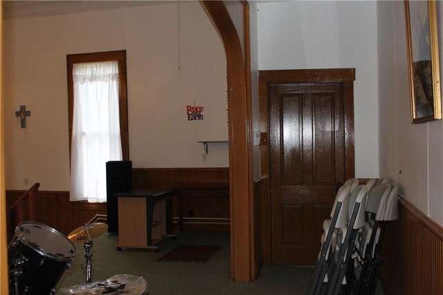 home office with wooden walls and carpet