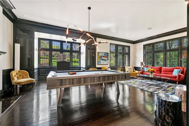 rec room with ornamental molding, plenty of natural light, pool table, and dark hardwood / wood-style flooring