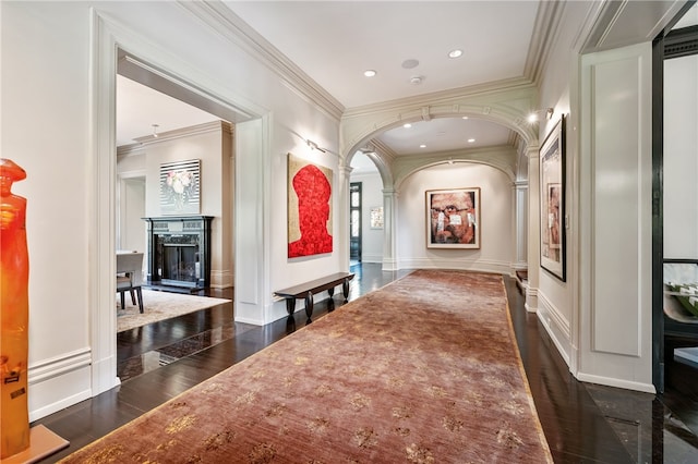 hall with dark hardwood / wood-style floors and ornamental molding