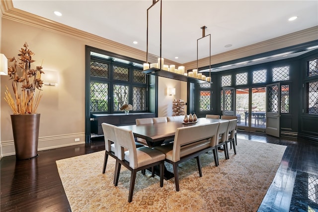 dining area with ornamental molding and dark hardwood / wood-style flooring