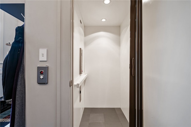 hall featuring tile patterned flooring and elevator