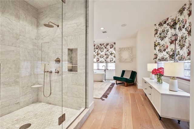 bathroom with vanity, separate shower and tub, and hardwood / wood-style flooring