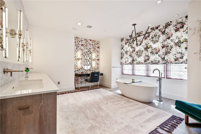 bathroom featuring tile patterned flooring, a tub to relax in, and vanity