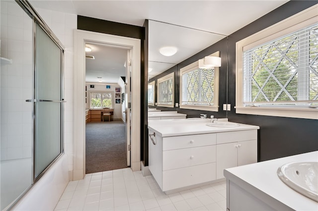 bathroom featuring vanity, tile patterned floors, combined bath / shower with glass door, and a wealth of natural light