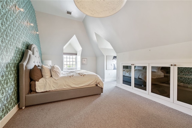 carpeted bedroom with vaulted ceiling