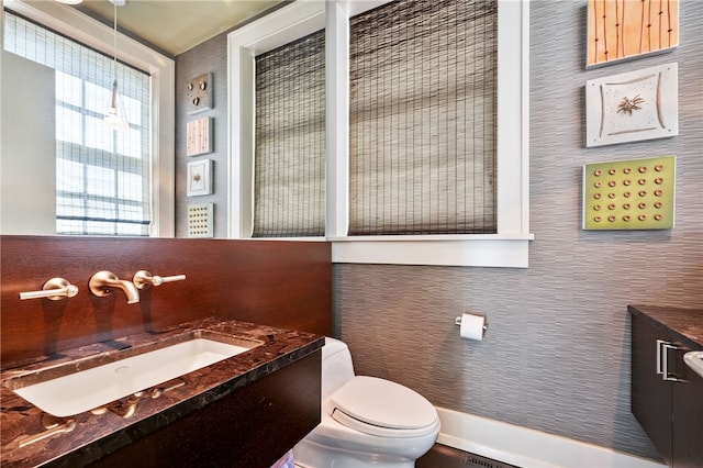 bathroom featuring vanity and toilet