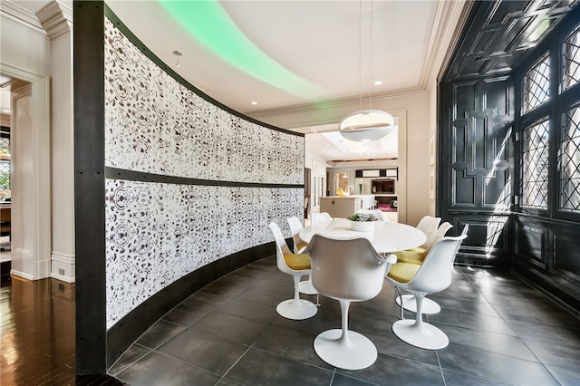 dining area featuring crown molding and dark hardwood / wood-style flooring