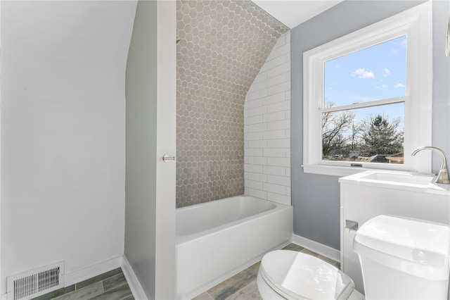 bathroom featuring toilet, sink, lofted ceiling, and wood-type flooring