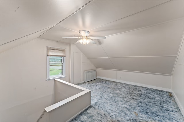 additional living space featuring radiator, vaulted ceiling, ceiling fan, and carpet flooring