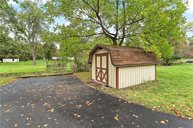 view of outbuilding with a lawn