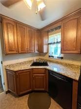 kitchen with dishwasher, ceiling fan, sink, and light stone counters