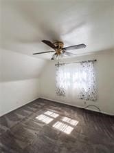 additional living space with vaulted ceiling and ceiling fan