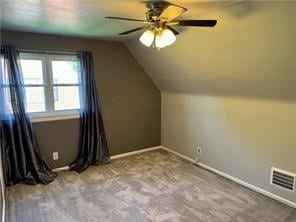 additional living space with vaulted ceiling, ceiling fan, and light colored carpet