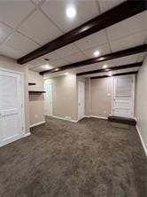 basement with a paneled ceiling