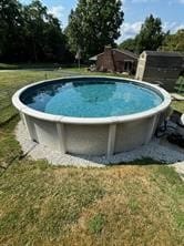 view of pool with a lawn