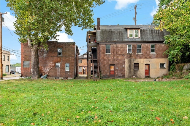 rear view of property with a yard