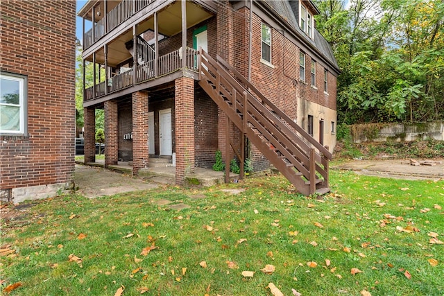 exterior space with a yard, a balcony, and a patio area