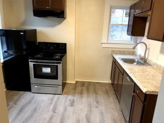 kitchen featuring dark brown cabinetry, sink, extractor fan, stainless steel appliances, and light hardwood / wood-style floors