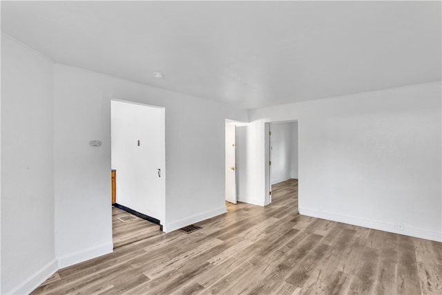 spare room with light wood-type flooring