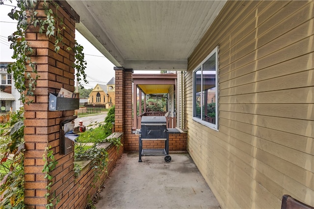 view of patio / terrace with area for grilling and a porch