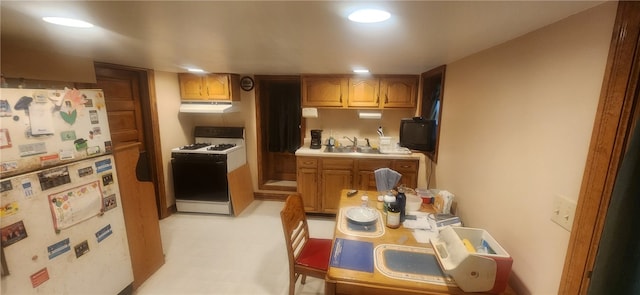 kitchen featuring white appliances and sink