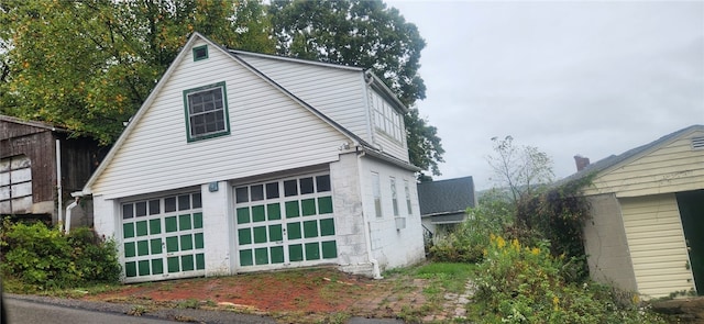 view of home's exterior featuring an outbuilding and a garage