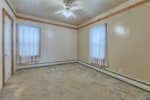 spare room with baseboard heating, ceiling fan, and light colored carpet