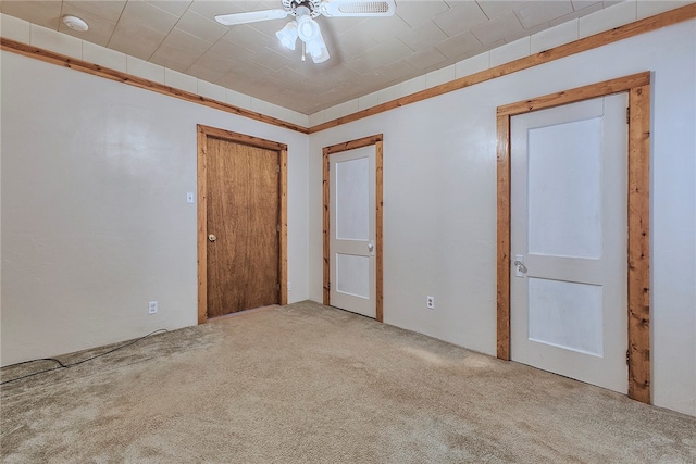 unfurnished bedroom featuring carpet and ceiling fan