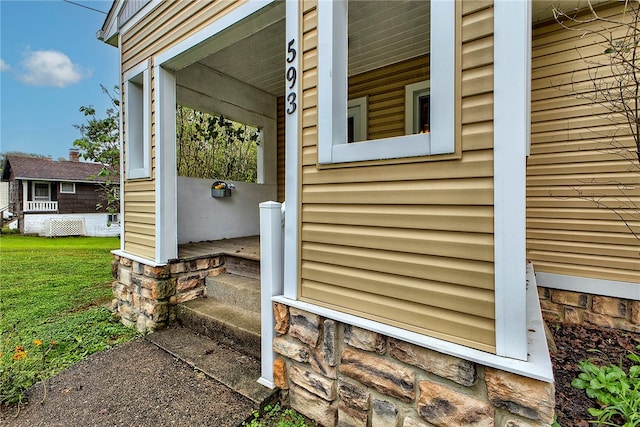 property entrance with a lawn