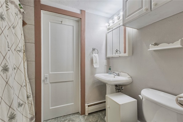 bathroom featuring a baseboard radiator and toilet