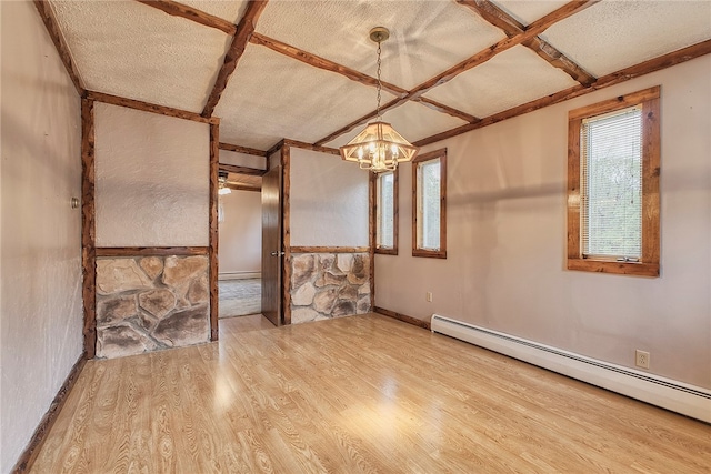 empty room featuring wood-type flooring, a textured ceiling, a baseboard heating unit, coffered ceiling, and an inviting chandelier