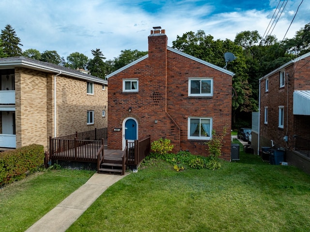 rear view of house featuring a yard and a deck